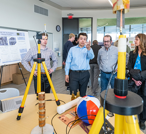Students share their STEM projects with business leaders and community members.