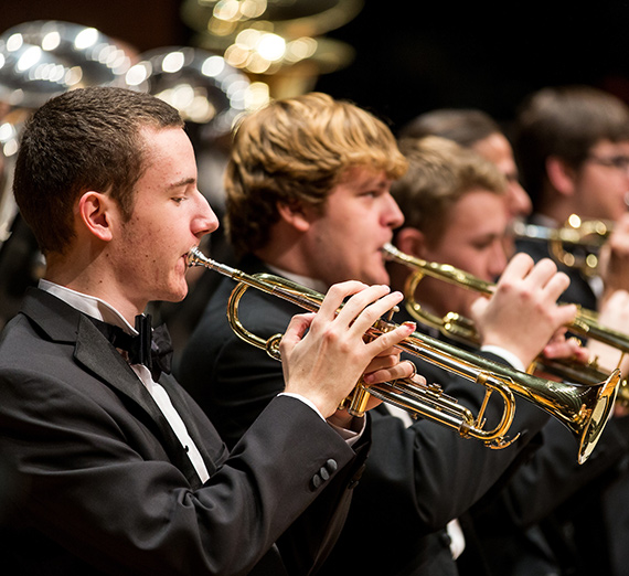 Members of the brass section of the Wind Symphony rehearse for a concert