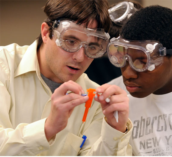 A professor helping a student in lab 