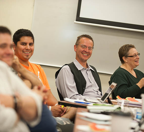 Doctoral Program Students and Professor at table