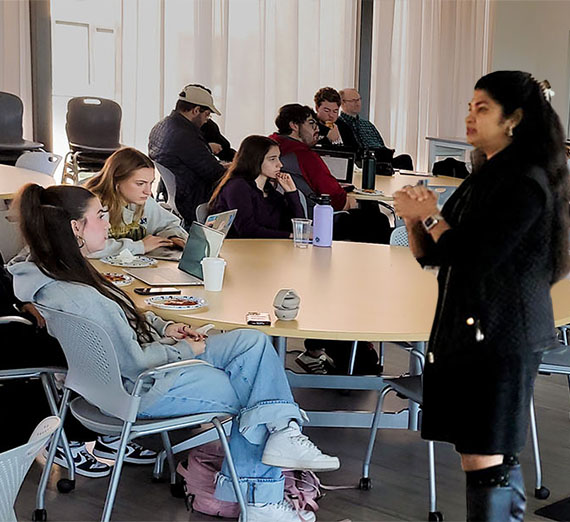 group of students listen to speaker