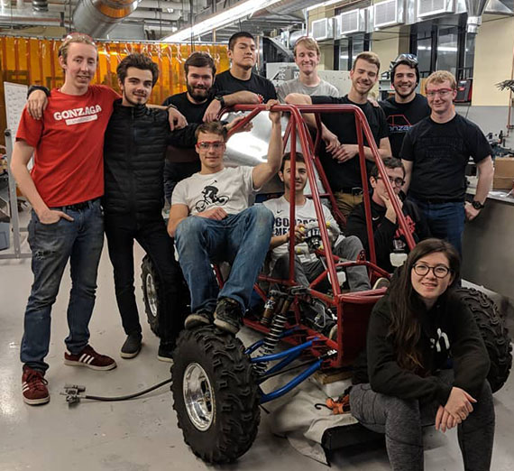 A few of the students of the 2018 build team with their 2018 entry