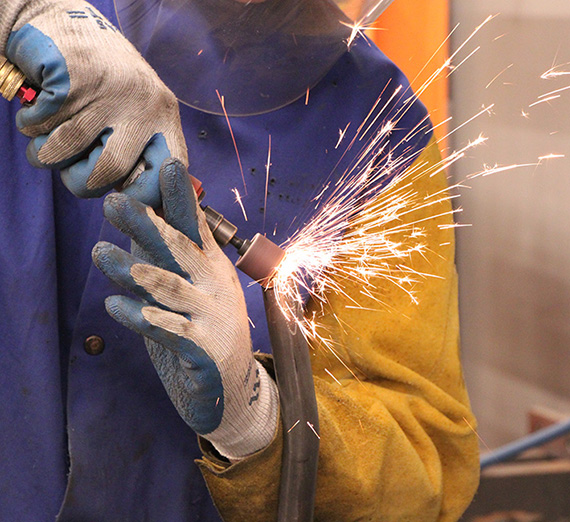 two engineering students stand next to their academic poster