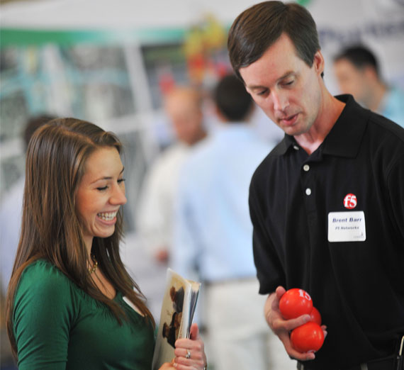 Engineering student talking with employer at a career fair 