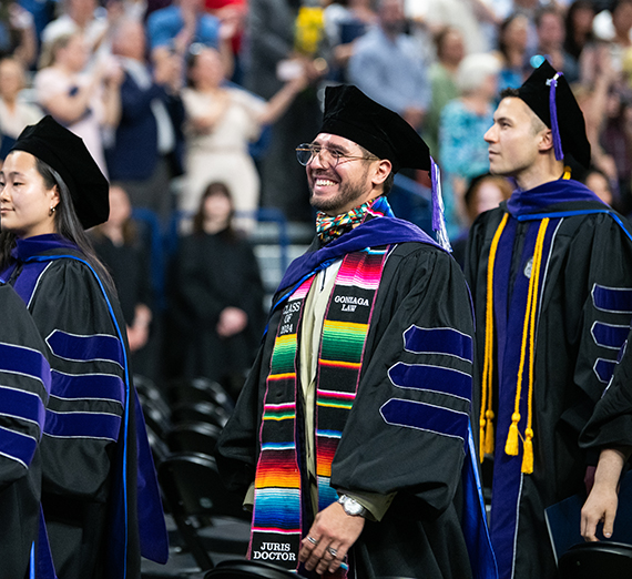 Law school graduates standing proudly at graduation