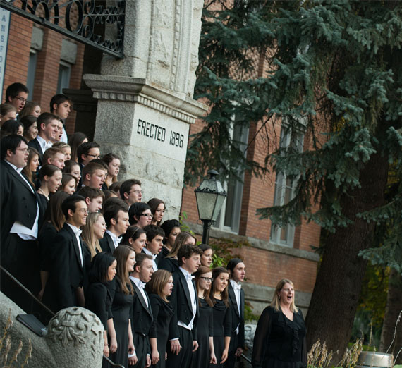 choir singing on steps of college hall 