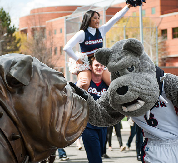 Mascot Spike petting Statue Spike on campus.
