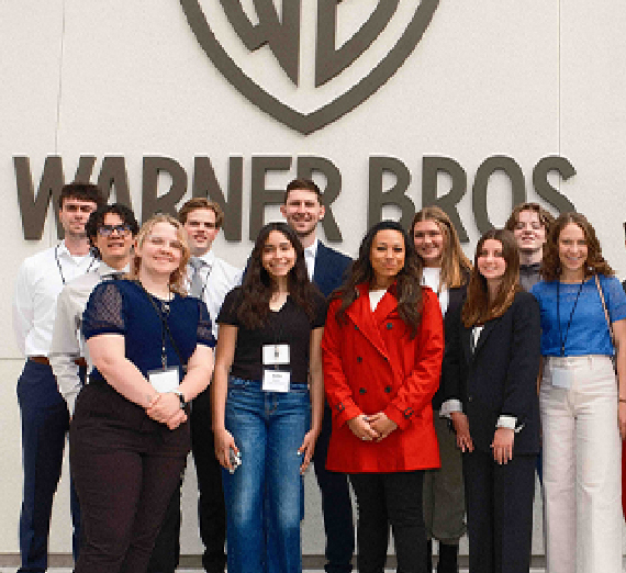 Gonzaga students on the Los Angeles career trek stand foreground of the Warner Bros. company sign