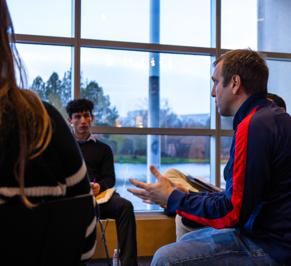 interior shot Gonzaga students listen to a Nike employee at Nike headquarters during their Portland career trek