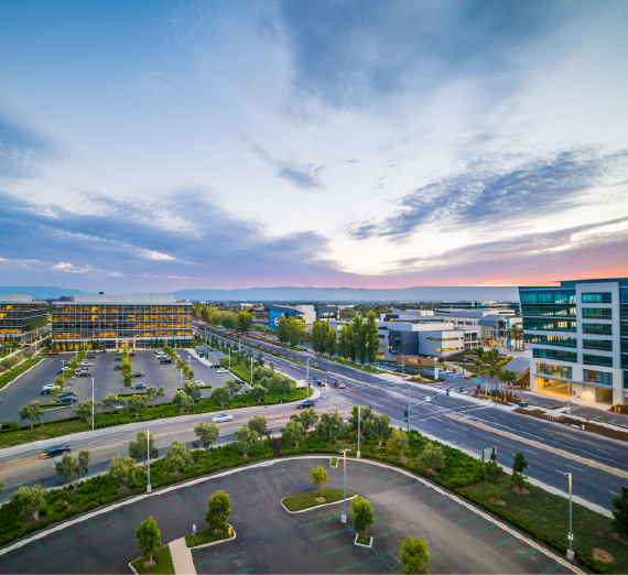 Exterior shot of nondescript Silicon Valley business parking lot