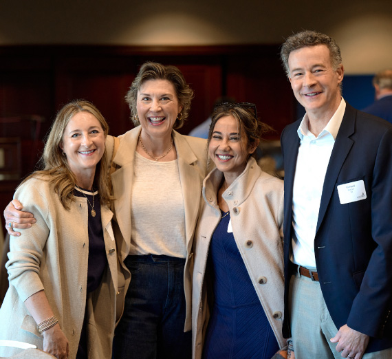 Group of four attendees of Forging Forward Bellevue pose for a camera at the event.