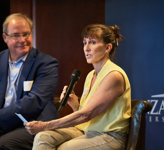 Event moderators speak onstage at the Forging Forward Bellevue event