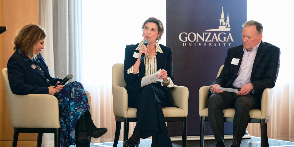 President Passerini and moderators on stage speak to audience