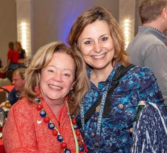 Gonzaga president Katia Passerini, Ph.D. poses with attendee of the ZagUp event at the WCC Basketball Tournament in Las Vegas.