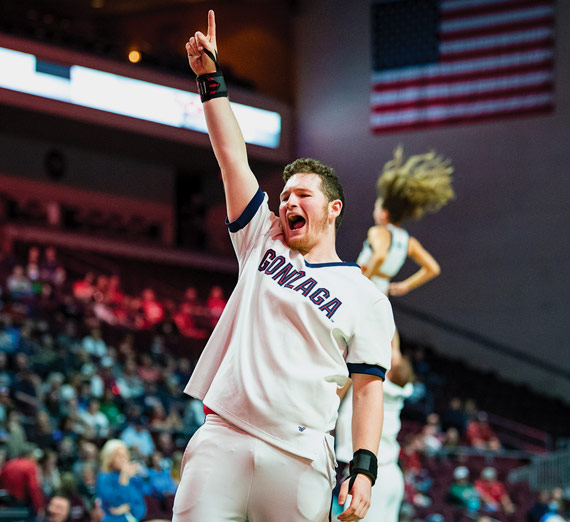A Gonzaga cheerleader rallies the crowd at a basketball game.