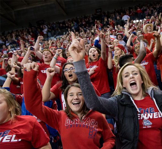 students cheering at basketball game 
