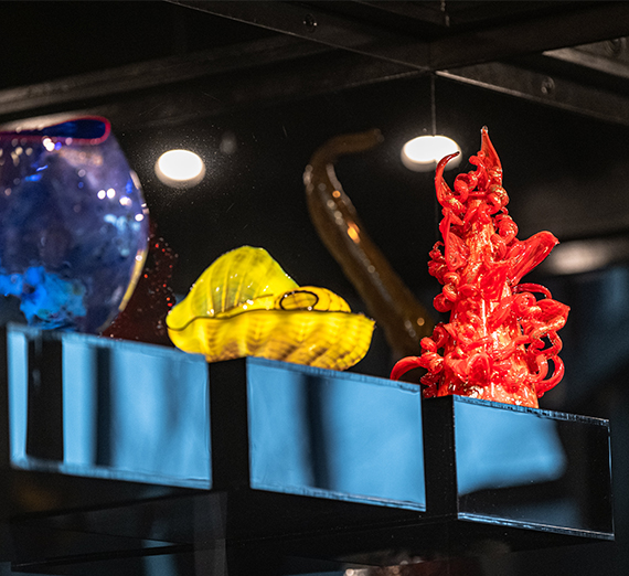 A red glass sculpture stands out on display.