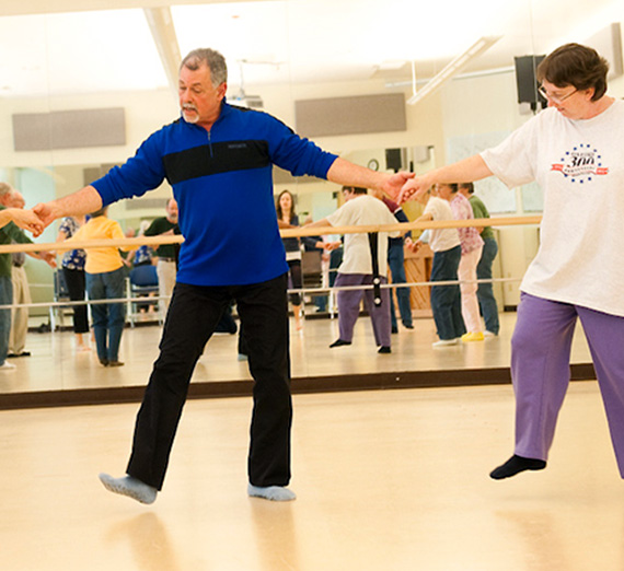 Participants in the Dance Parkinson's program dance in the studio.