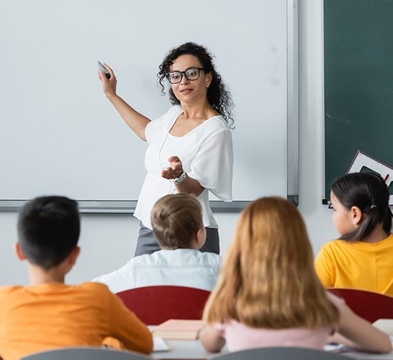 A teacher addresses a class of elementary students.