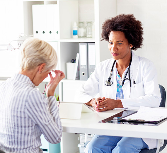 A woman discusses the medical properties and uses of cannabis with a health care provider.