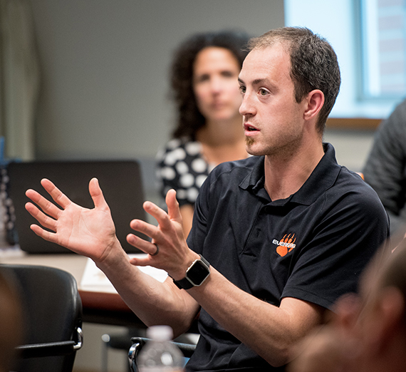 A school principle talks during a leadership seminar.