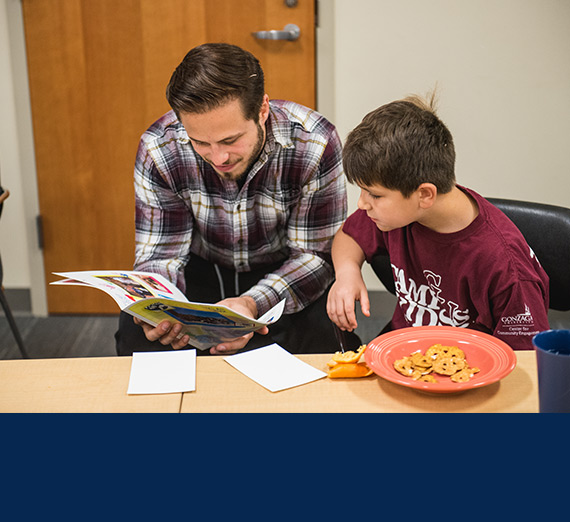 A teacher reads to a student.
