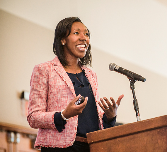 A young woman speaks at a leadership symposium.