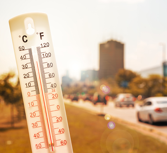 kids learning at a table in a classroom with teacher standing nearby