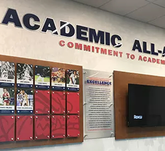 Academic All-American wall of fame with photos and names.
