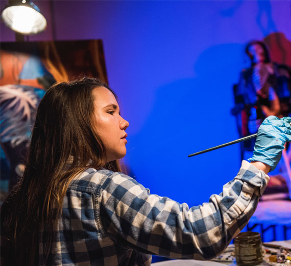 student painting in class