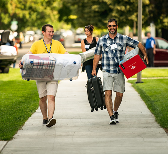 A new student moves his stuff in on Orientation Weekend.
