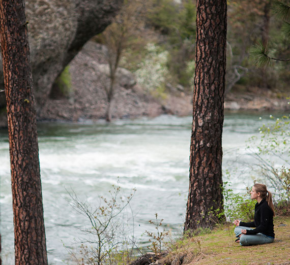 Student sitting by the rivers