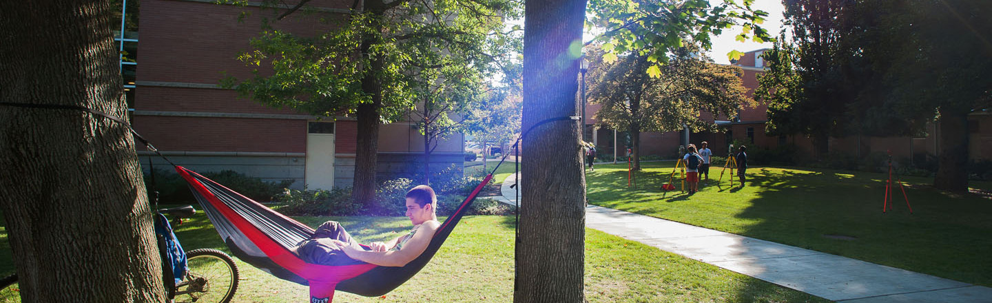 Student studying in hammock