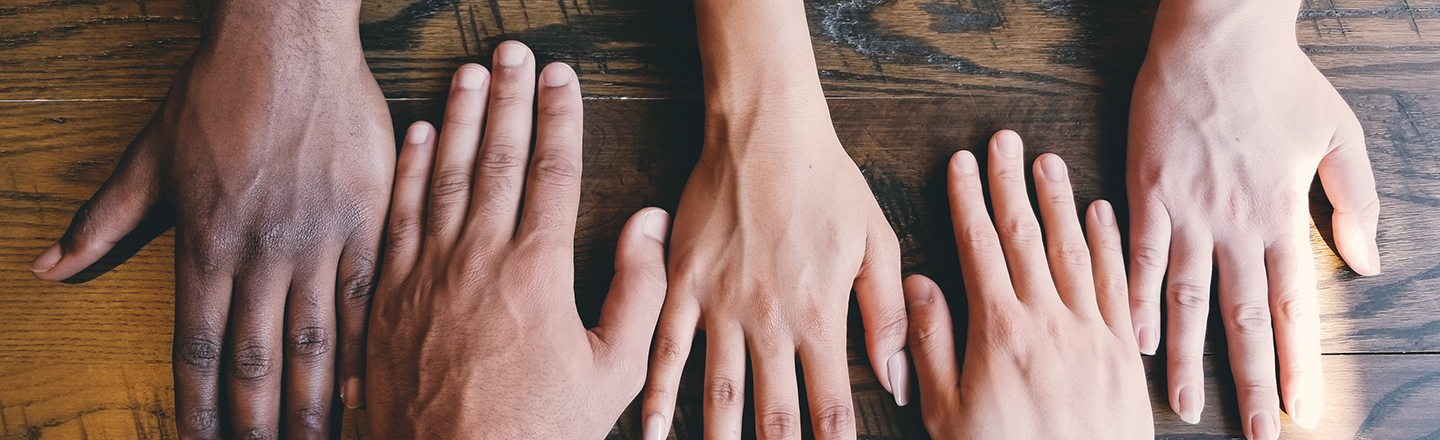 Close up of hands with different skin tones.