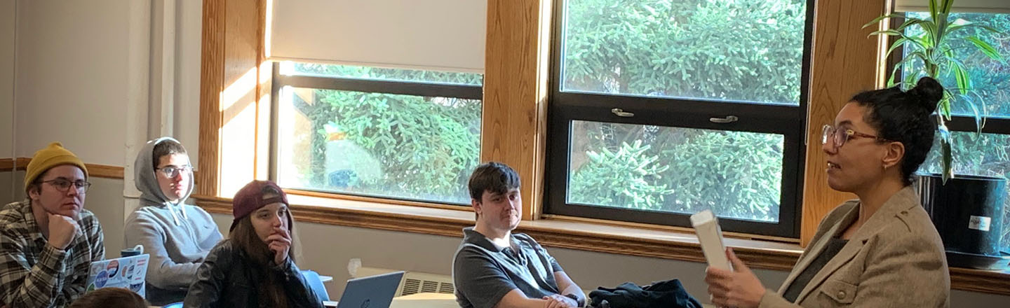 Post doc instructor teaches students in class.