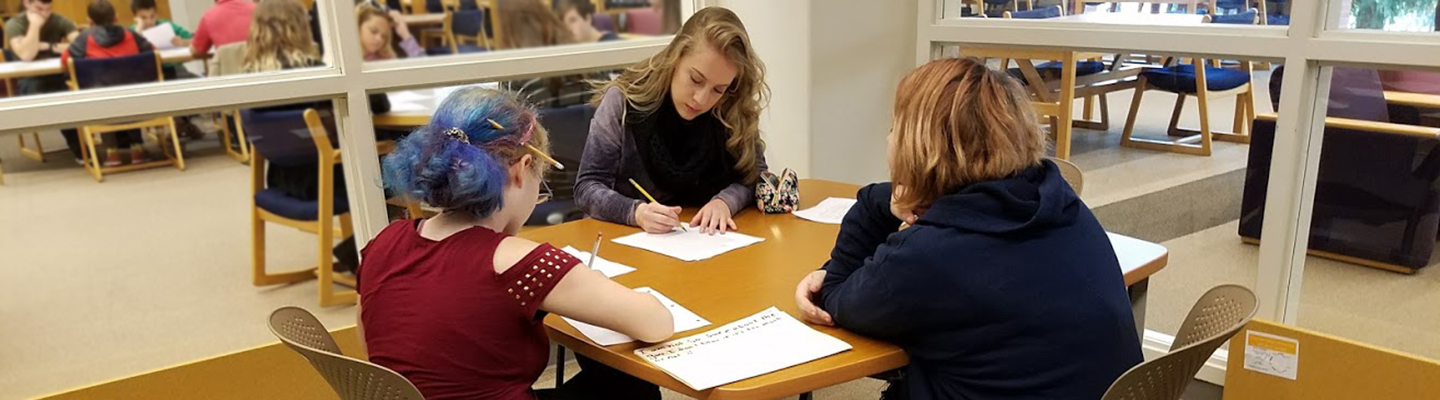 Students working in a group at a table in the Gonzaga Writing Center