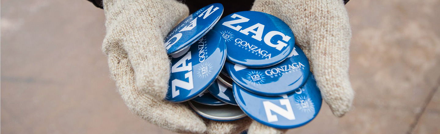 Person holding Zag Support buttons with gloves on