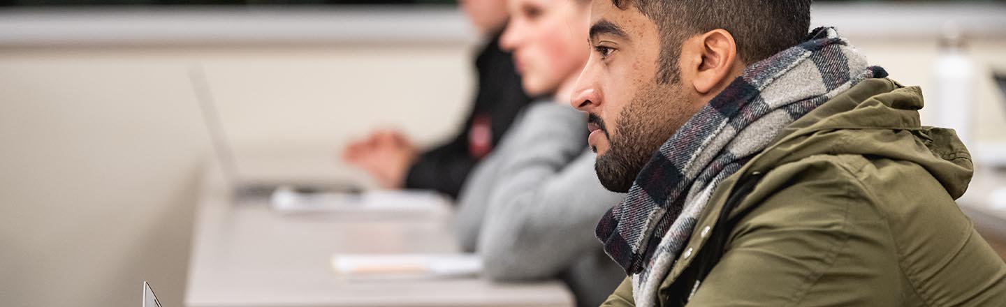 Students listening to instructor at desks
