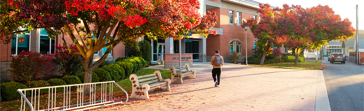 Student walks into the School of Education building in the fall