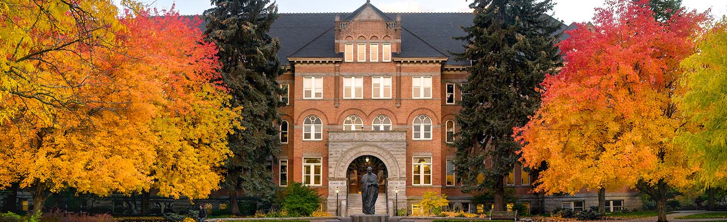View of College Hall with fall leave colors in red, orange, and green.