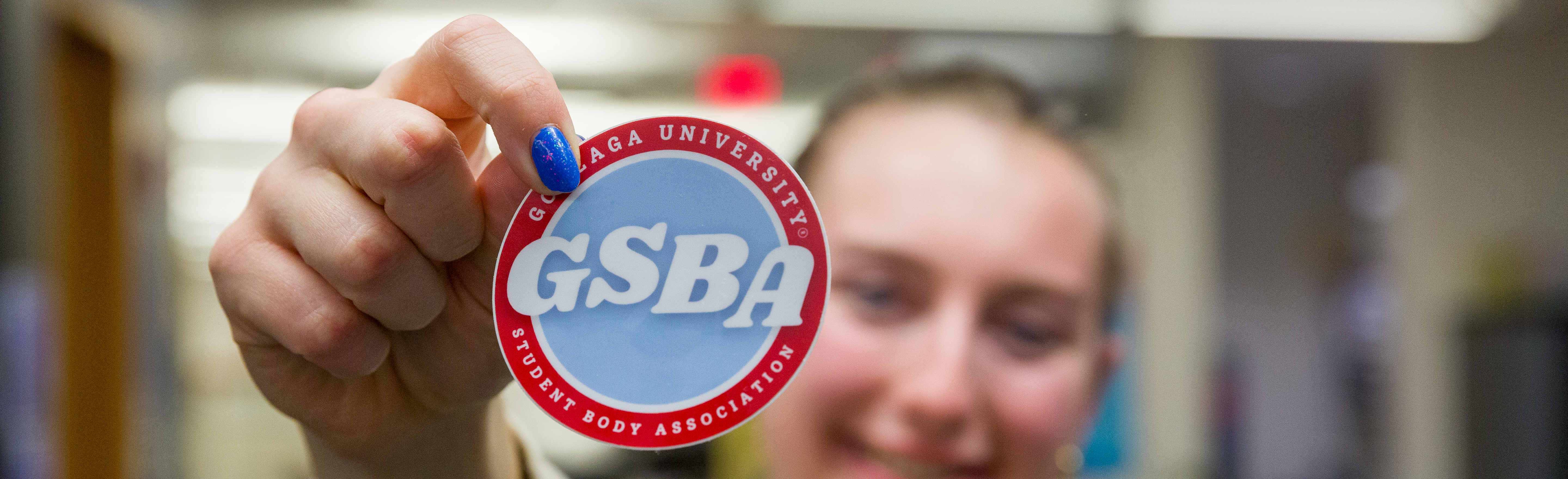 Student displaying a GSBA sticker