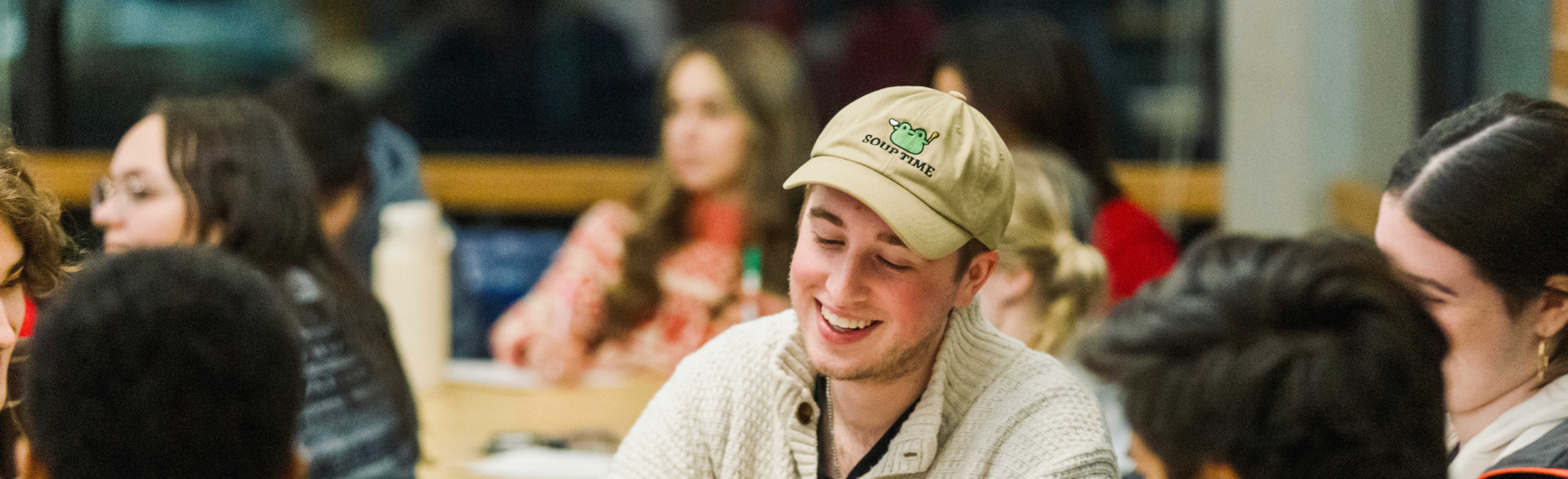 A student smiling in a meeting