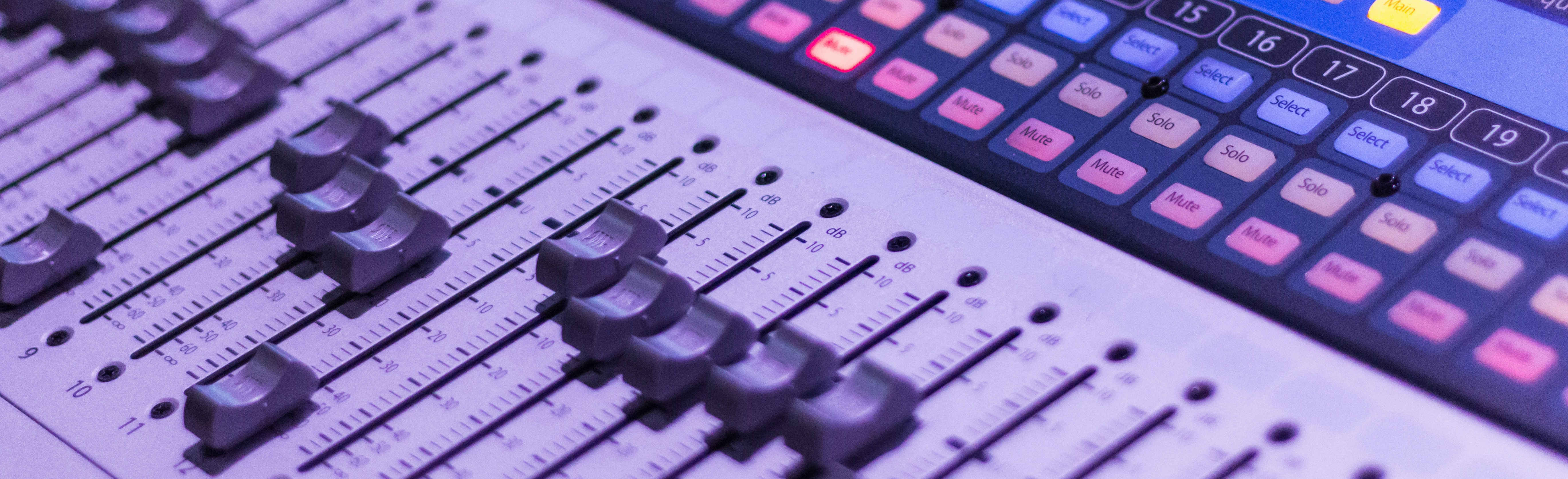 Close-up view of an audio mixing board