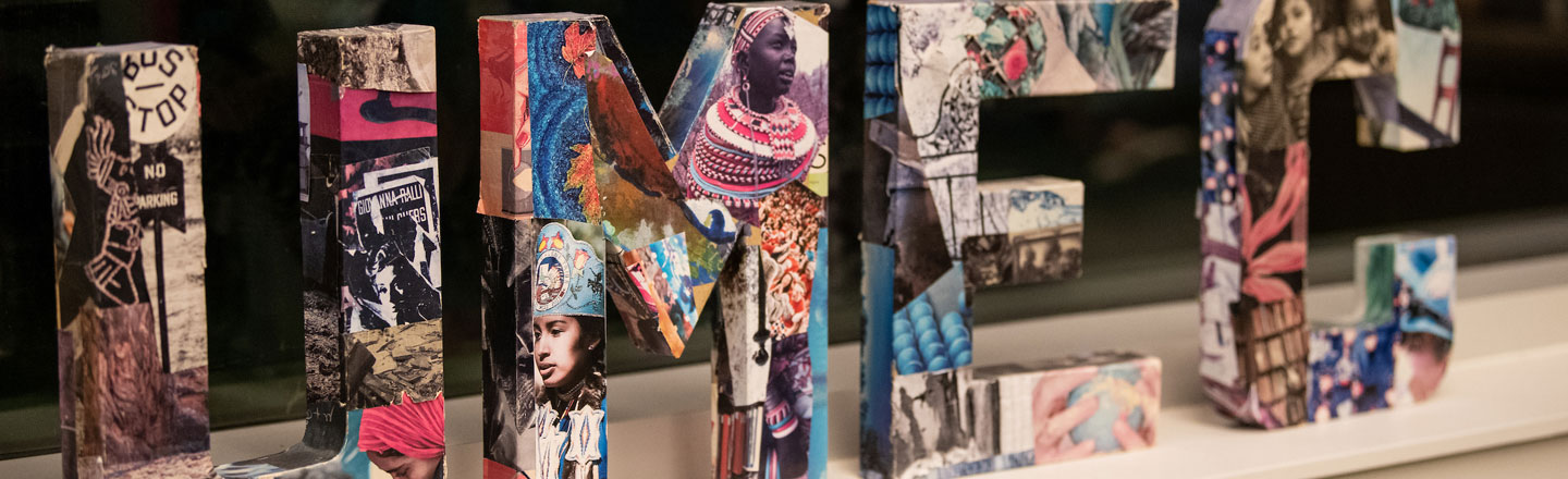 Colorful, three-dimensional art piece of the UMEC letters, wrapped in vibrant images of diversity.