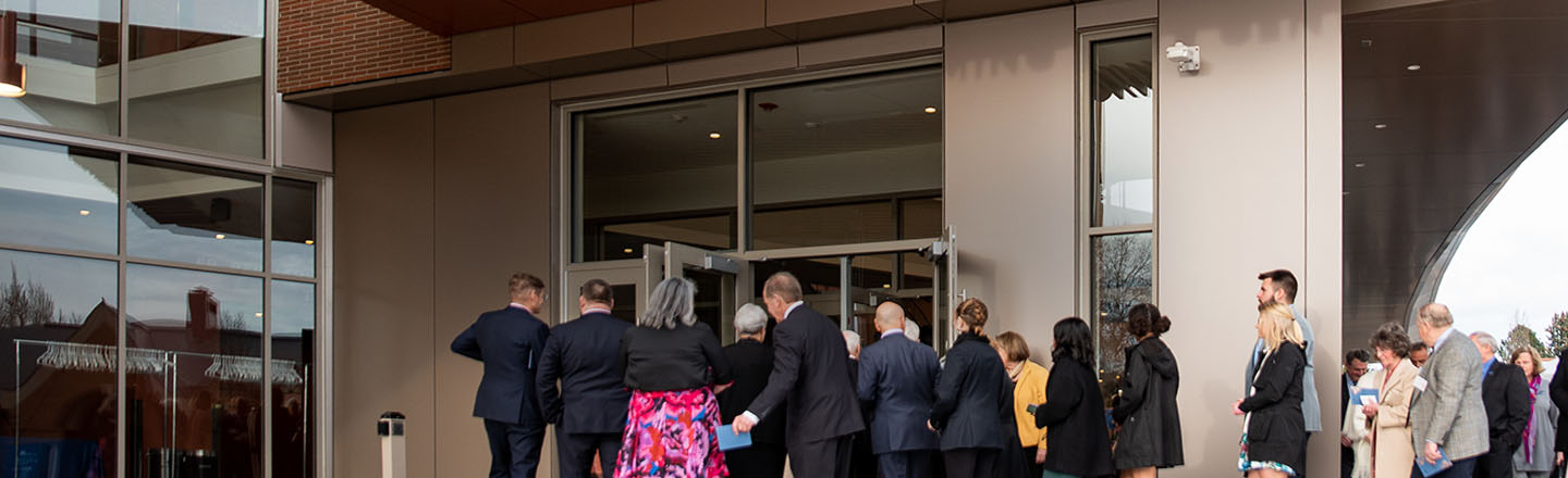 theatre-goers entering the front doors of the performing arts center