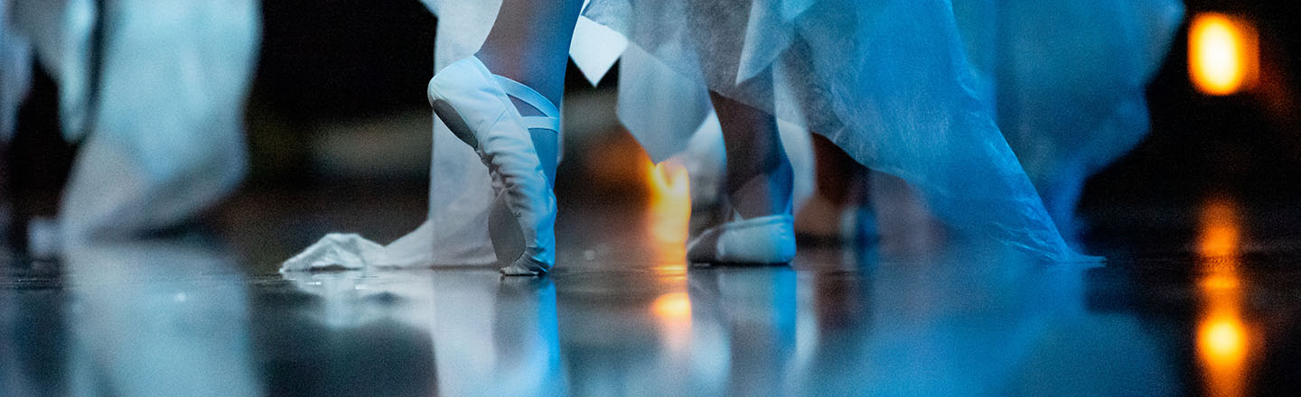 dancer's feet with dance slippers in ballet pose