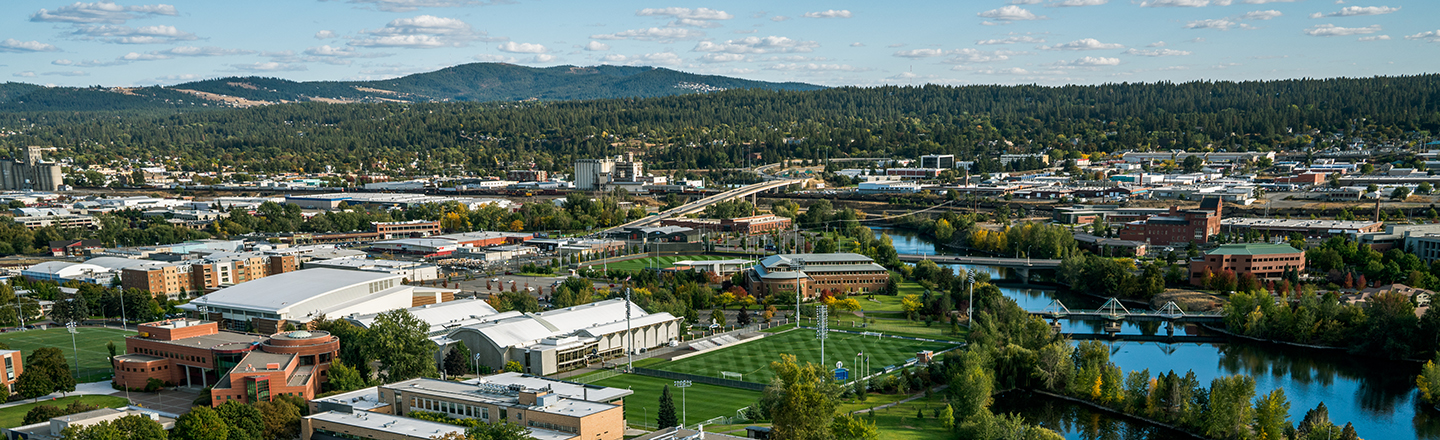 Arial view of the Gonzaga campus surrounded by rivers and mountains.