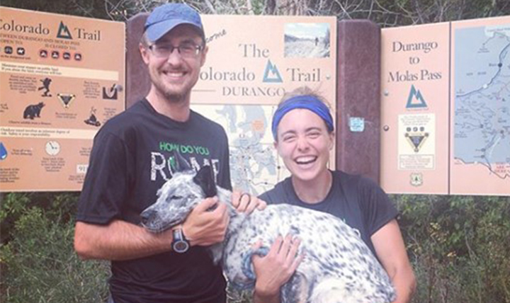 Williams and Devereaux smile with their dog Aska at the trailhead. 