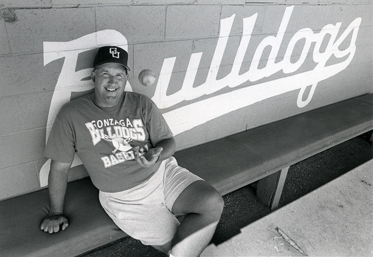 Steve Hertz tosses up a baseball in Gonzaga's dugout.