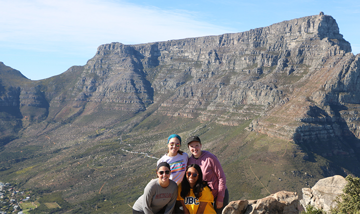 Four students pose on top of Table Mountain in Cape Town. 